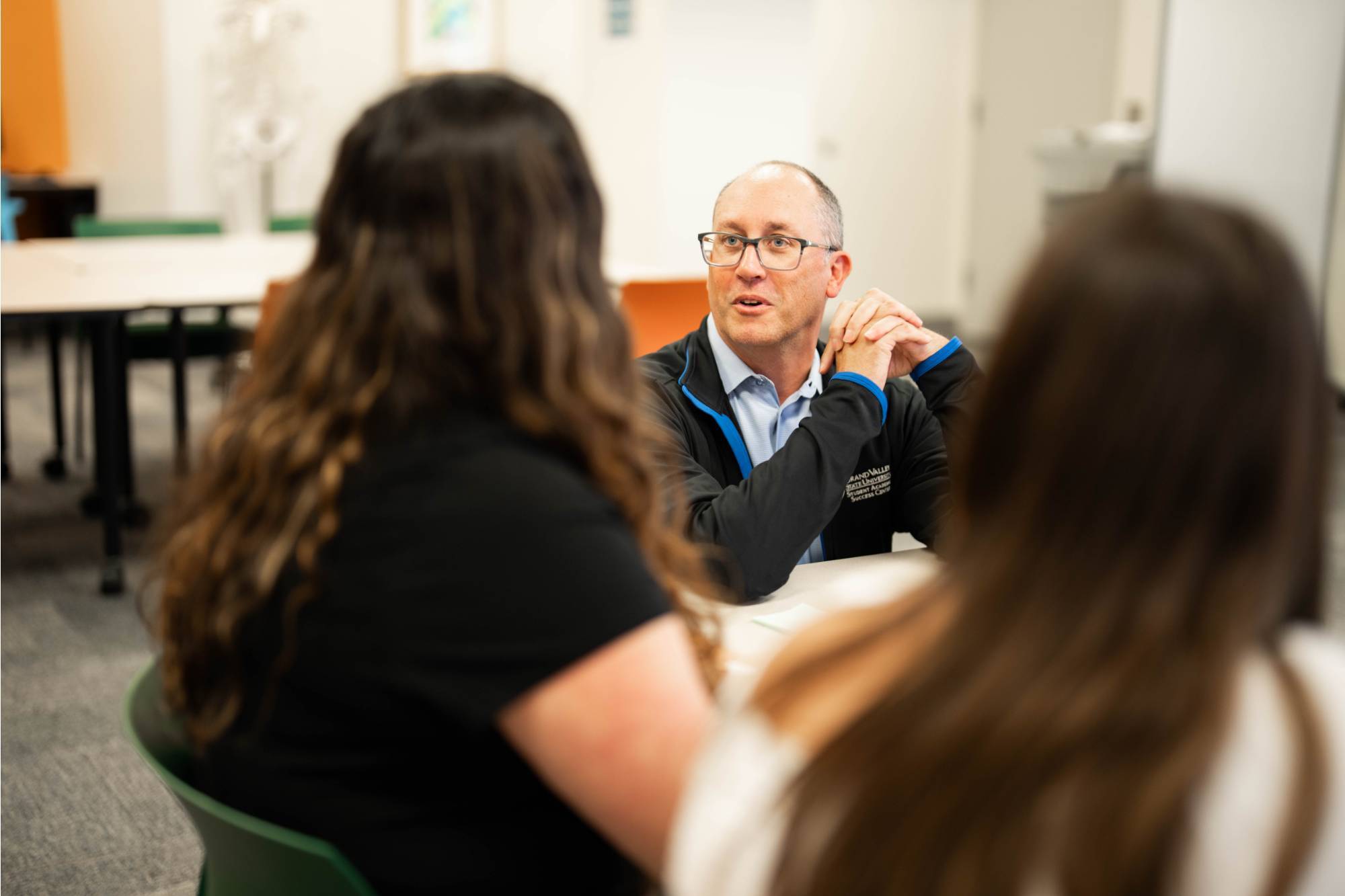 Decorative: Success coach working with students